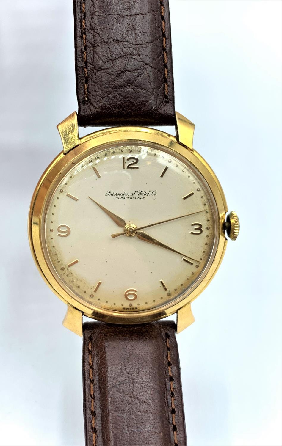 A vintage 18ct gold IWC watch with leather strap, in working order.