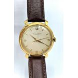 A vintage 18ct gold IWC watch with leather strap, in working order.