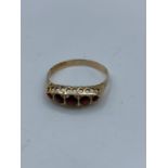 Vintage 9ct rose gold ring with garnet stones, size O and weight 1.16g approx