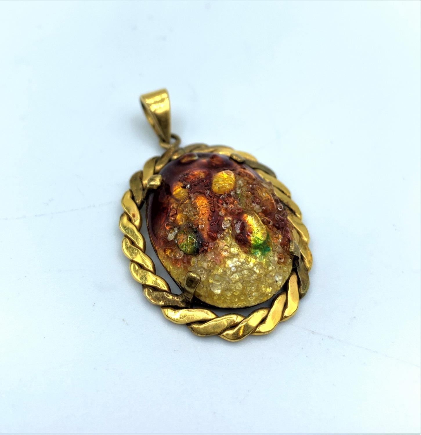 Yellow metal pendant with Limoges multi coloured centre stone, weight 5.9g and 3cm long