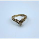 A 9ct yellow gold 3 band chevron ring with small diamond centre stone, weight 1.9g and size L/M