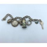 Vintage Silver Charm Bracelet with 7 Charms. 32.9g. 15cm