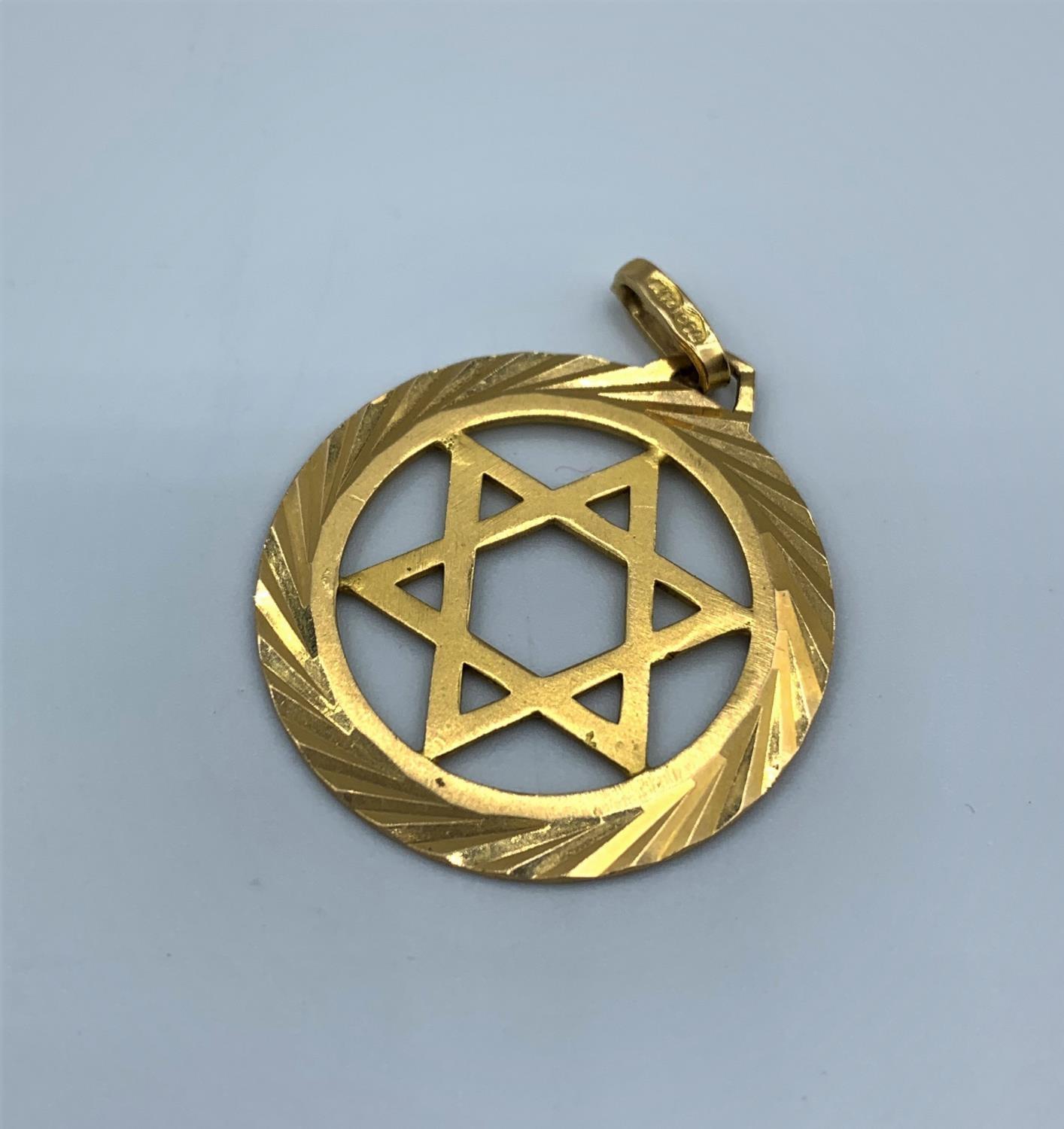 An 18ct yellow gold Star of David pendant with ornate surround, weight 3.8g approx