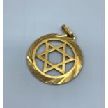 An 18ct yellow gold Star of David pendant with ornate surround, weight 3.8g approx