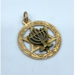 A vintage 9ct yellow gold star of David pendant with central Menorah, weight 2g