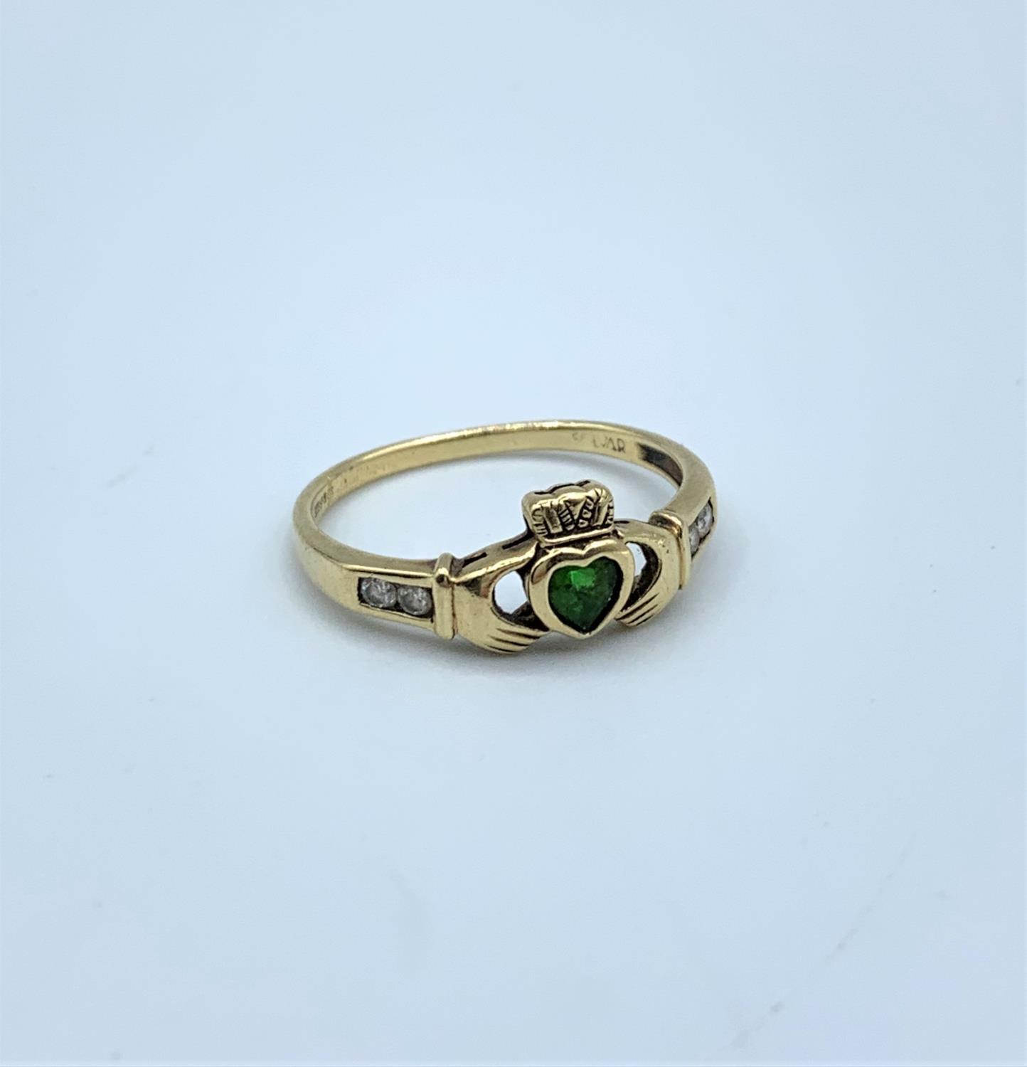 A 9ct claddagh ring with emerald and diamonds size R, weighing 2g.