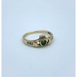 A 9ct claddagh ring with emerald and diamonds size R, weighing 2g.