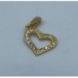 Heart shaped pendant with encrusted CZ stones set in 14k yellow gold, weight 1.26g approx