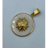 Mother of pearl pendant with sun design set in 18k yellow gold, approx 25mm diameter and weight 3.