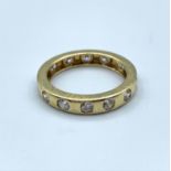 14ct yellow gold eternity ring with white stones, weight 3.8g and size R