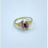18ct yellow gold ring with a pink ruby centre stone flanked by small diamonds, weight 2g and size N
