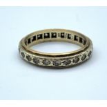 A vintage eternity ring with 9ct gold outer bands and a silver centre band, weighs 2.9g and size P.