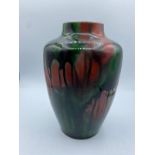 Red and green mottled studio drip glaze stoneware vase. Stamped to base MH with a star. size 21cm H