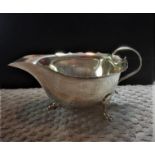 Antique hallmarked silver Mappin & Webb sauce boat, having scroll handle and three cabriole legs,