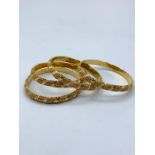 Set of 4x 21ct yellow gold bangles, weight total 63.6g approx, 7cm diameter and 10mm band wide
