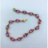 9ct gold attractive bracelet with pink stones, approx 15cm long and weight 8.5g