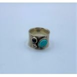 Vintage large silver band with turquoise and dressing stones, size U and weight 13.6g approx