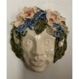 Art Nouveau style studio pottery wall face mask, adorned with flowers. size 16cm H X 14cm W