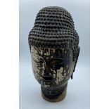 An early large hand carved wooden Buddha's head, possibly Japanese with remnants of black paint over
