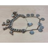 Chunky silver curb bracelet with 6 silver charms and heart padlock, interlinked with an inner silver