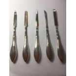 Antique silver handled manicure set, having 5 pieces including the rare silver handled tweezers,