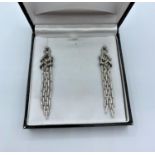 Pair of 18ct white gold drop earrings with with encrusted diamonds, approx 65mm long and 15mm width,