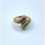 18ct diamond encrusted cross over ring with pink rubies and emerald facings, weight 3.2g and size K