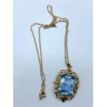 9ct gold pendant with large blue stone on 42cm long necklace, weight 7.1g
