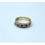 A half eternity ring in 9ct yellow gold with diamonds & pink ruby's. Weighs 2.2g and size I