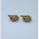 Pair of 18ct gold earrings with small diamonds in the centre flanked by 4 further diamonds, weight