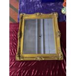 Gilt framed rectangular mirror. 60cm W x 70cm H including scrolled corner frame.