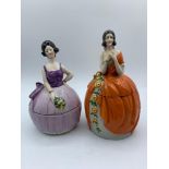 Vintage pair of Ceramic powder boxes in the form of ladies in orange and purple ballgown dresses