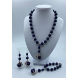 A Lapis Lazuli Necklace, Bracelet and Earrings Set Incorporating Bird Claws with CZ Pendants.