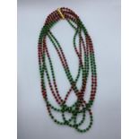 Six row Emerald and Ruby Necklace with Gold Plated spacer beads and clasp, weight 146g Emeralds