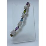 Silver Bracelet stone set with Amethyst, Topaz and Peridot coloured stones separated by 9 larger