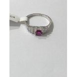 18ct White gold Ring with 4x4mm Ruby centre and 12 Princess Cut Diamonds (approx 0.24ct), weight 2.