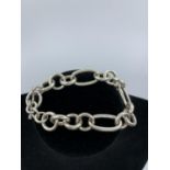 Silver Bracelet with large oval and round links, having a T Bar clasp and hallmark showing on the
