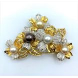 A Diamond encrusted 18ct Gold Brooch with 3 colours of Natural Pearls enhanced with yellow and white