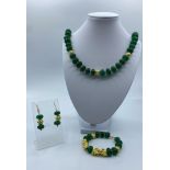 A Chinese Dark Green Jade Necklace, Bracelet and Earrings Set.