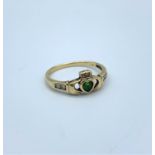 A 9ct Claddagh Ring with Emerald and Diamonds size R, weighing 2g.