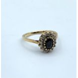 9ct Gold Ring with Blue Centre Stone and CZ stones surrounding it, weight 1.9g and size L