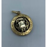 A yellow metal Victorian Mourning Locket with Gold and enamel front, weight 4.5g