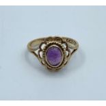 Vintage 9CT yellow Gold Ring with purple stone centre, size H and weight 1.7g approx