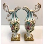Pair of Baroque ornate Vases with handles on a gold base, 28cm tall with raised flower to both sides