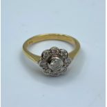 9ct yellow gold ring with floral shaped encrusted diamond face and 0.5ct diamond centre stone,