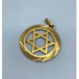 An 18ct yellow Gold Star of David Pendant with ornate surround, weight 3.8g approx