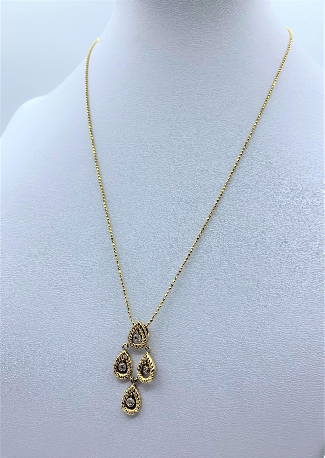 Diamond Drop Pendant in 18K Gold on a 9K Gold Chain, weight 3.1g and 36cm long chain