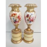 A heavily repaired pair of H&R Daniel baluster Vases floral theme, 16cm tall (2)