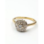 Stone set 18ct Gold Ring having a Diamond Centre stone with a further 8 diamonds circular