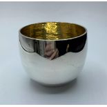 A hallmarked silver bowl/cup with gilt finish made by cousins of Canterbury, weighs 224g and is